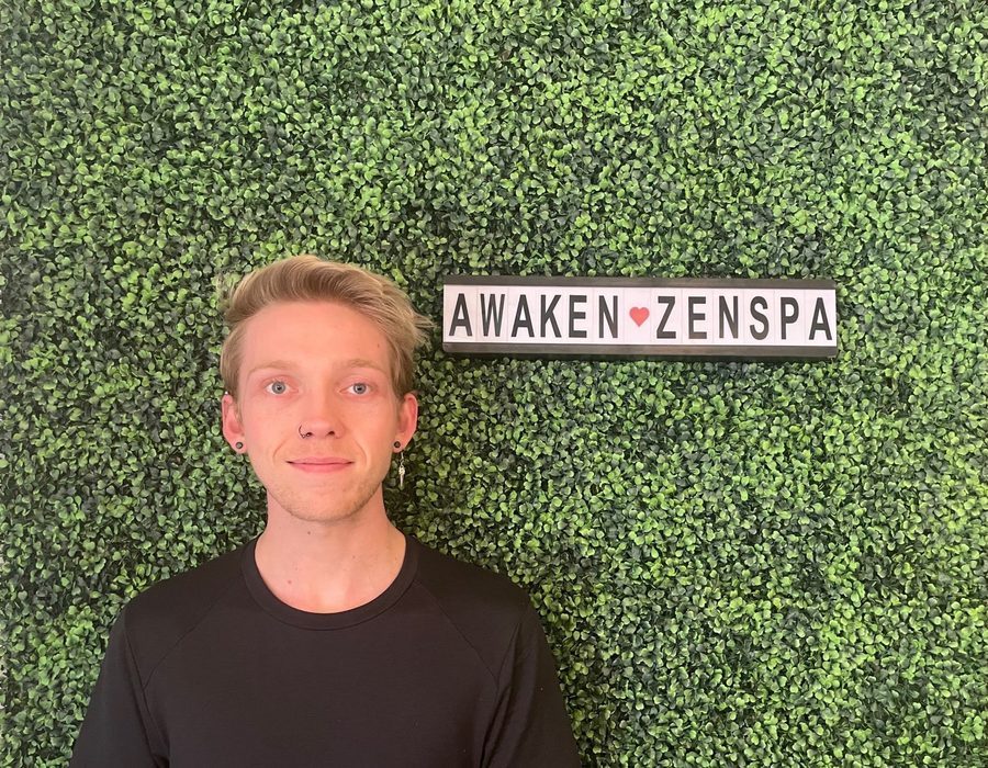 Esthetician analyzing skin before a customized facial at Awaken Zen Spa, Mesa AZ